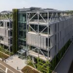 Modern Architectural Structure with Visible Metal Framework, Emphasizing Sustainability and Innovation.