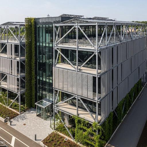 Modern Architectural Structure with Visible Metal Framework, Emphasizing Sustainability and Innovation.